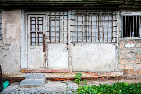 Boarded up window and old door of a old houseの写真素材