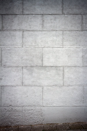 Gray plastered street wall and a pavementの写真素材