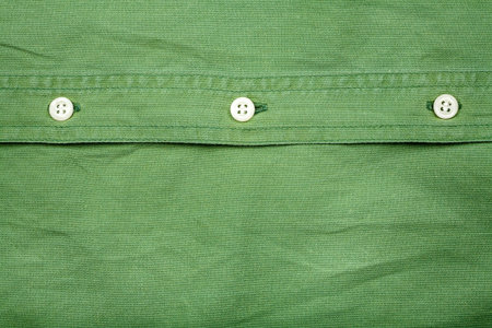 Green fabric texture with buttons background