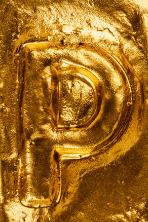 Beautiful handmade letter P on a shiny gold texture