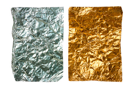 Two old crumpled pieces of aluminum foil isolated on white backgroundの写真素材