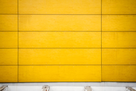 Modern  weathered yellow wall texture backgroundの写真素材