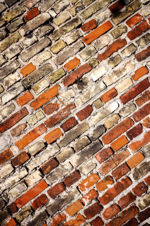 Background of yellow and red brick wall textureの写真素材