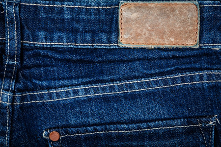 Blank leather jeans label sewed on a blue jeans