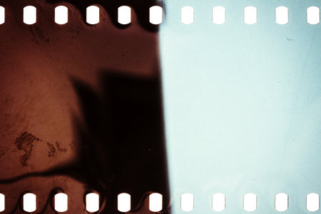 Blank grainy film strip texture background with lots of dust, noise and light leakの写真素材