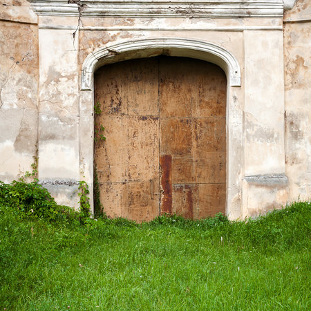 Old gates in a abandoned plaster wallの写真素材