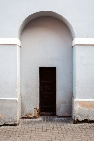 Brown door in old light blue wallの写真素材