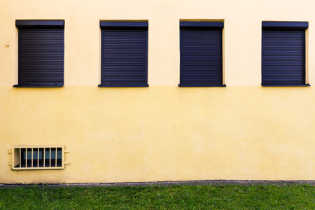 Modern yellow street wall with some windows
