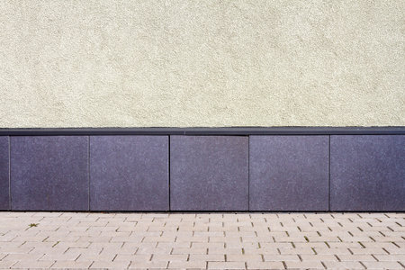 Modern yellow plaster street wall backgroundの写真素材