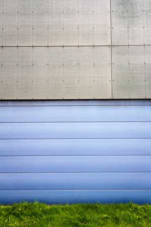 Modern blue and gray tile wall and green grassの写真素材