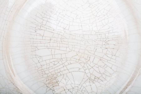 White handmade crackled pottery plate texture backgroundの写真素材