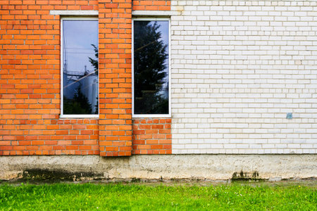 Red and white brick wall with some windowsの写真素材