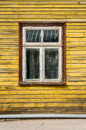 Old window on a aged wooden wall. Architectural detail. Architecture background.の写真素材