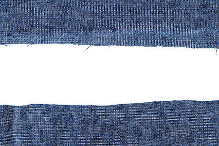 Pieces of dark blue jeans fabric isolated on white background. Rough uneven edges.