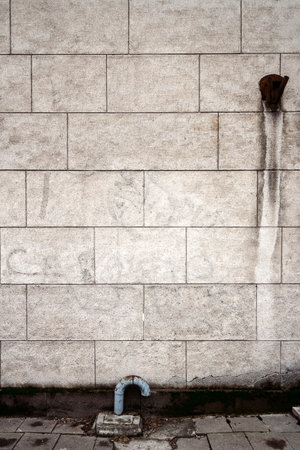 Aged weathered lined plaster street wall. Architecture detail backgroundの写真素材