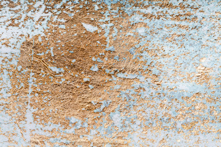White and golden messy wall stucco texture background. Decorative wall paint.