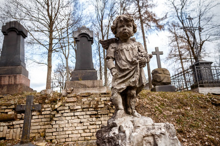 Statue of little boy Angel at Rasu cemetery in Vilnius, Lithuaniaの写真素材