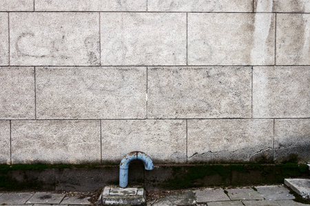 Aged weathered lined plaster street wall. Architecture detail backgroundの写真素材