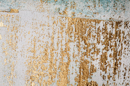White and golden messy wall stucco texture background. Decorative wall paint.の写真素材