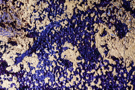 Purple with golden bumpy wall stucco texture backgroundの写真素材