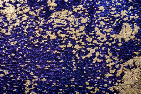 Purple with golden bumpy wall stucco texture backgroundの写真素材