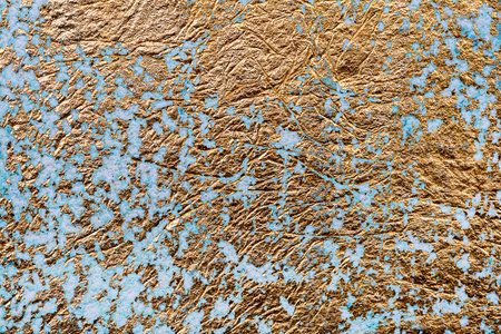 White and golden messy wall stucco texture background. Decorative wall paint.の写真素材