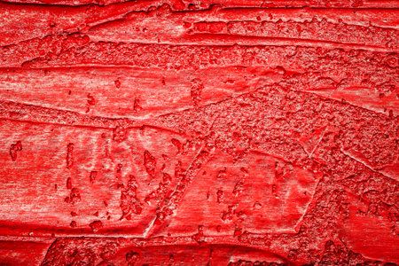 Red bumpy wall stucco texture background, crumpled leather imitationの写真素材