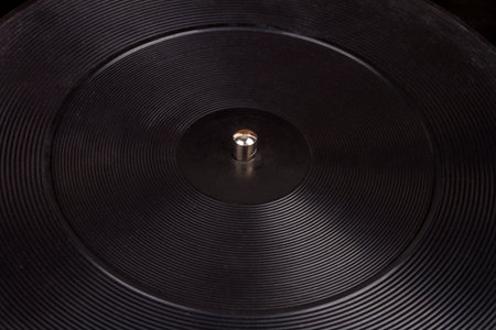 Close up shot of old turntable rubber platter with the spindle