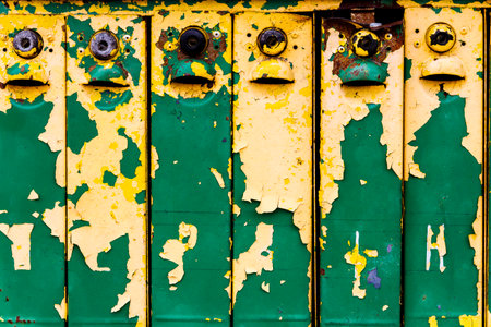 Close up shot of old weathered colorful iron mailboxesの写真素材
