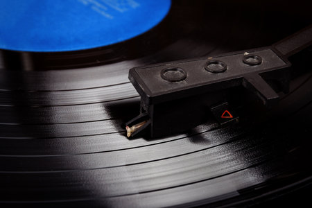 Turntable stylus on a vinyl record. Vintage vinyl record player. Needle on a black vinyl record.の写真素材
