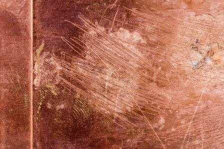 Scratched dirty dusty copper plate texture, old metal background. Cloudy and scratchy copper metal texture.の写真素材