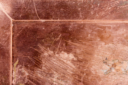 Scratched dirty dusty copper plate texture, old metal background. Cloudy and scratchy copper metal texture.の写真素材
