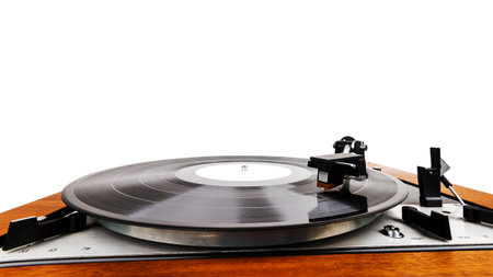 Close up of vintage turntable vinyl record player isolated on white. Wooden plinth. Retro audio...