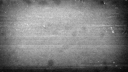 Noisy film frame with heavy scratches, dust and grain. Abstract old film backgroundの写真素材