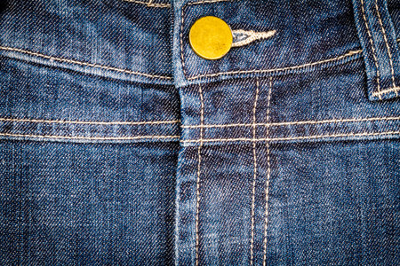 Worn blue denim jeans texture with stitches and button. Abstract jeans texture backgroundの写真素材