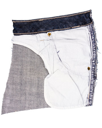 Piece of blue jeans fabric isolated on white background. Rough uneven edges. Denim jeans torn. Wrong side of jeans fabricの写真素材