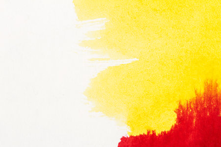 Abstract hand drawn yellow and red watercolor paints backgroundの写真素材