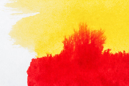 Abstract hand drawn yellow and red watercolor paints backgroundの写真素材