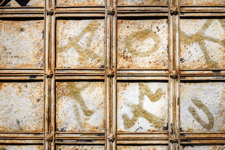Close up of ancient iron door. Decorative pattern of the old iron door.