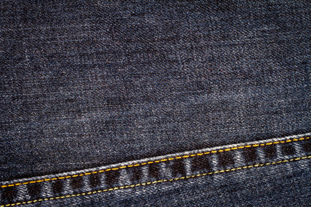Black jeans texture. Denim jeans fabric background with a seam.の写真素材