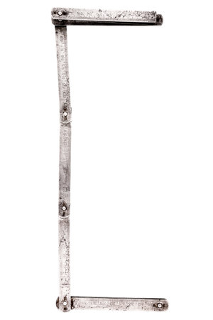 Old iron meter ruler. Old iron folding meter in the shape of letter C isolated on white background.