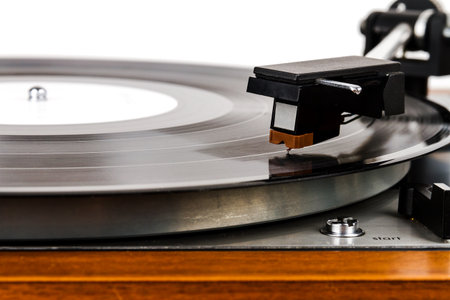 Close up of turntable needle on a vinyl record. Turntable playing vinyl. Needle on rotating black...