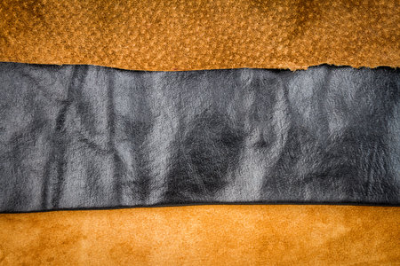 Genuine brown and black leather textures background. Abstract vintage natural cow skins backdrop. Different leather stripes.の写真素材