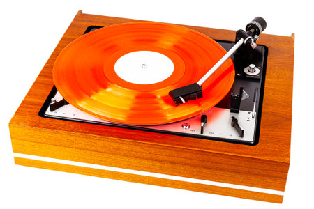 Vintage turntable with a red vinyl isolated on white. Wooden plinth. Retro audio equipment.の写真素材