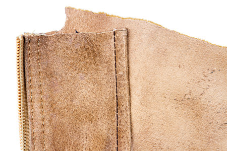 Piece of brown leather isolated on white background. Back side.