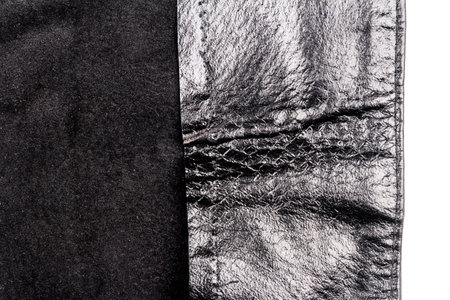 Piece of black leather isolated on white background. Crumpled material texture. Back sideの写真素材