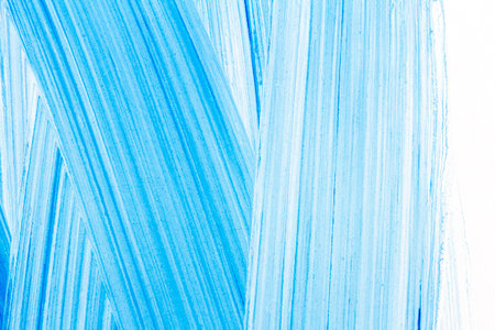 Abstract hand drawn blue acrylic paints background. Brushed texture close up.