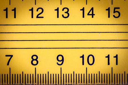 Yellow metal ruler close up with millimeters and centimetersの写真素材