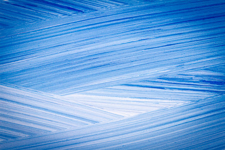 Abstract hand drawn blue acrylic paints background. Brushed texture close up.