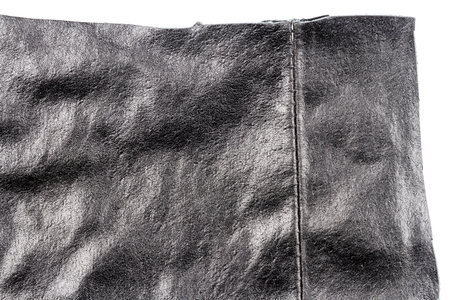 Piece of black leather isolated on white background. Crumpled material texture.の写真素材